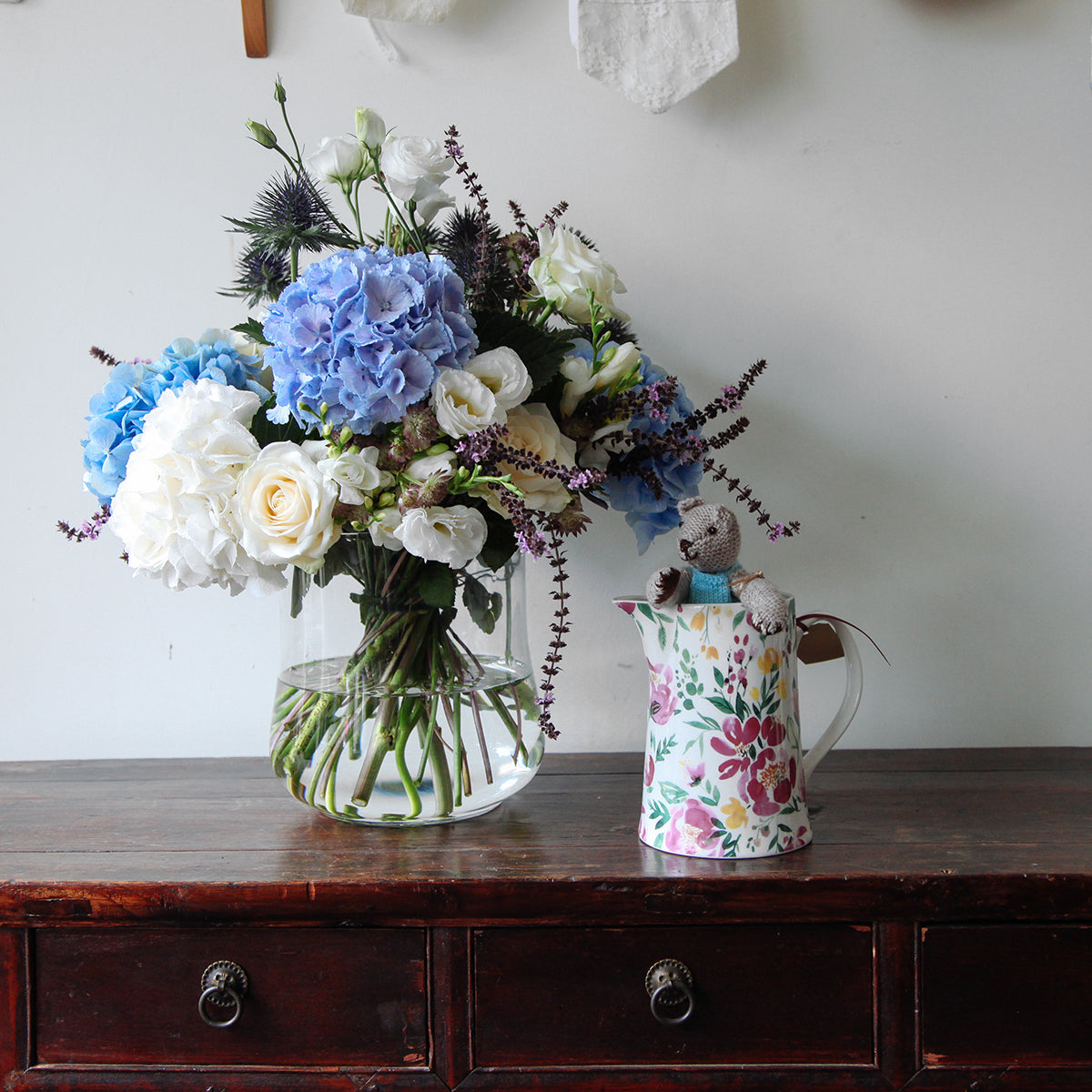 Blue and white hydrageas, white roses and lisianthus in a vase 