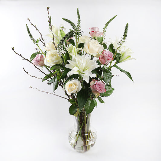 A bouqet with white lilies and dark pink roses