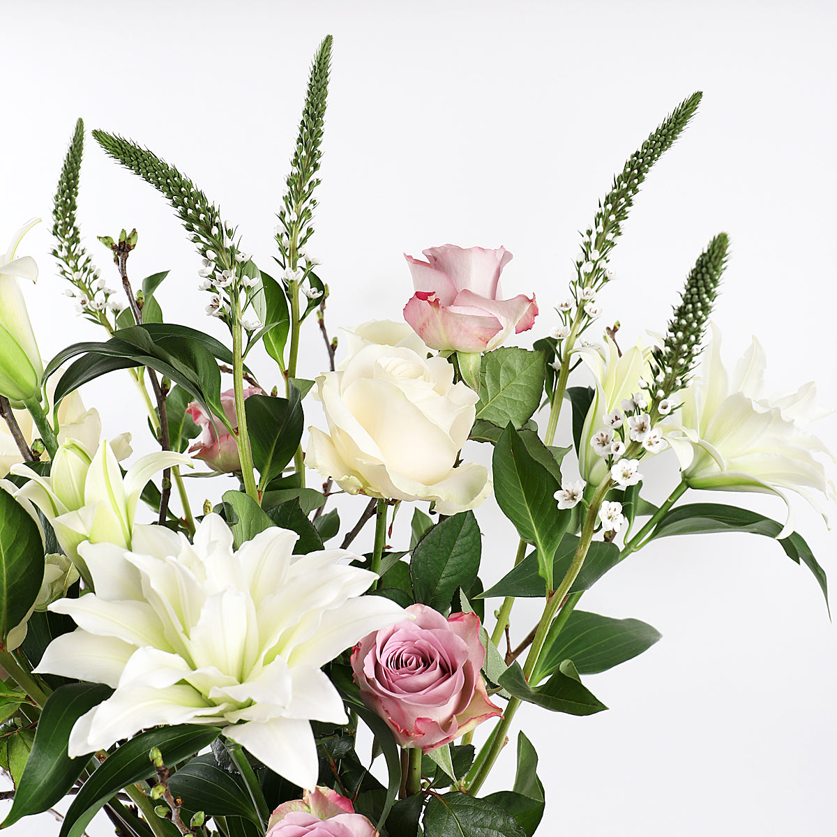 Detail view of white liles and dark pink roses