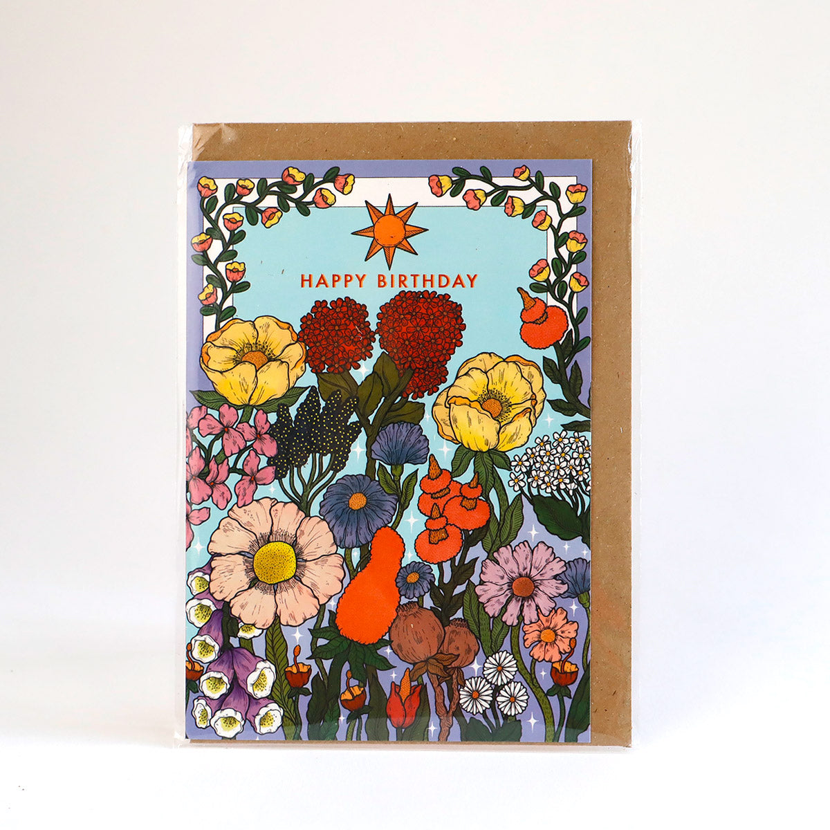 A greetings card illustrated with 60's inspired flowers and the words happy birthday