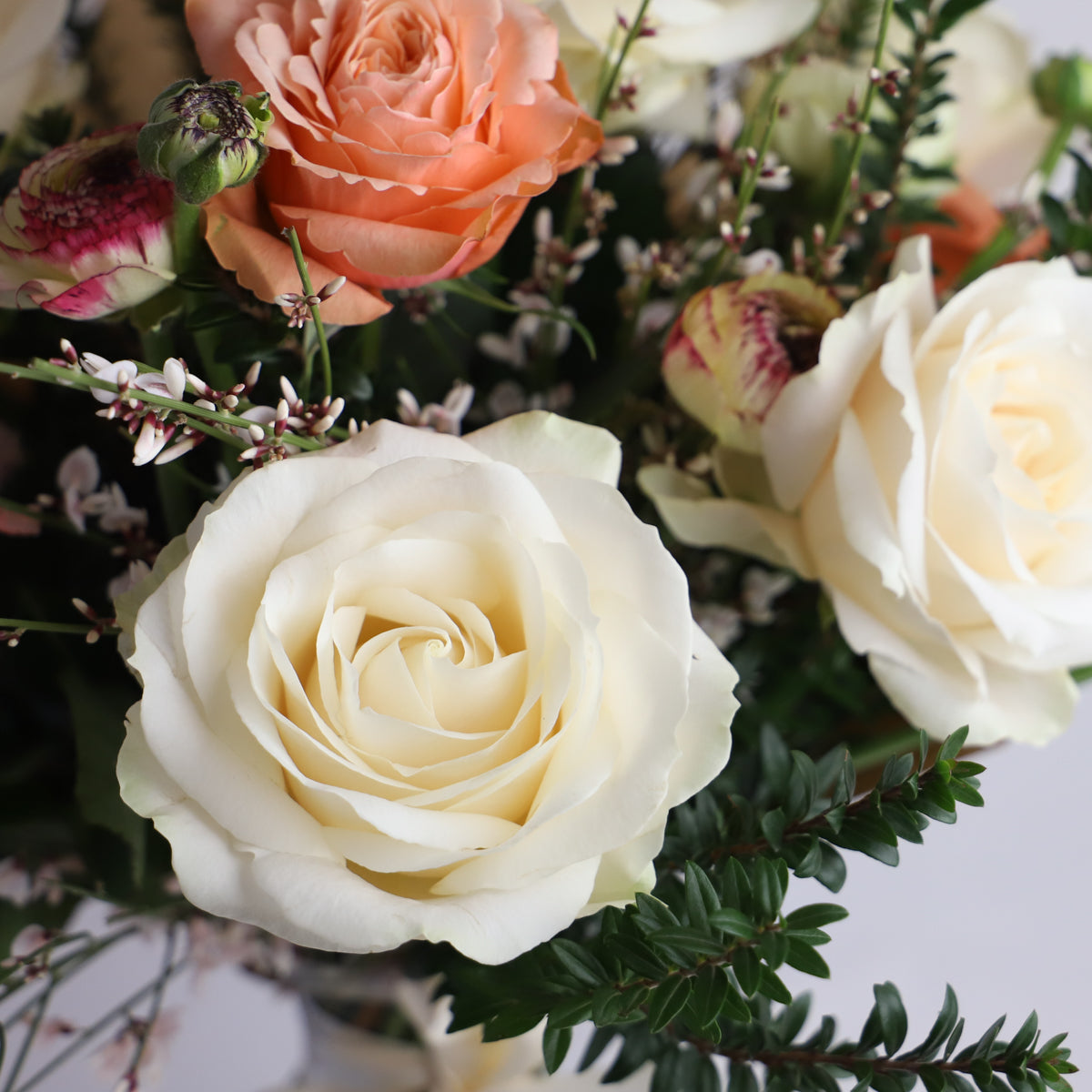 A detail shot of the cream and peach roses