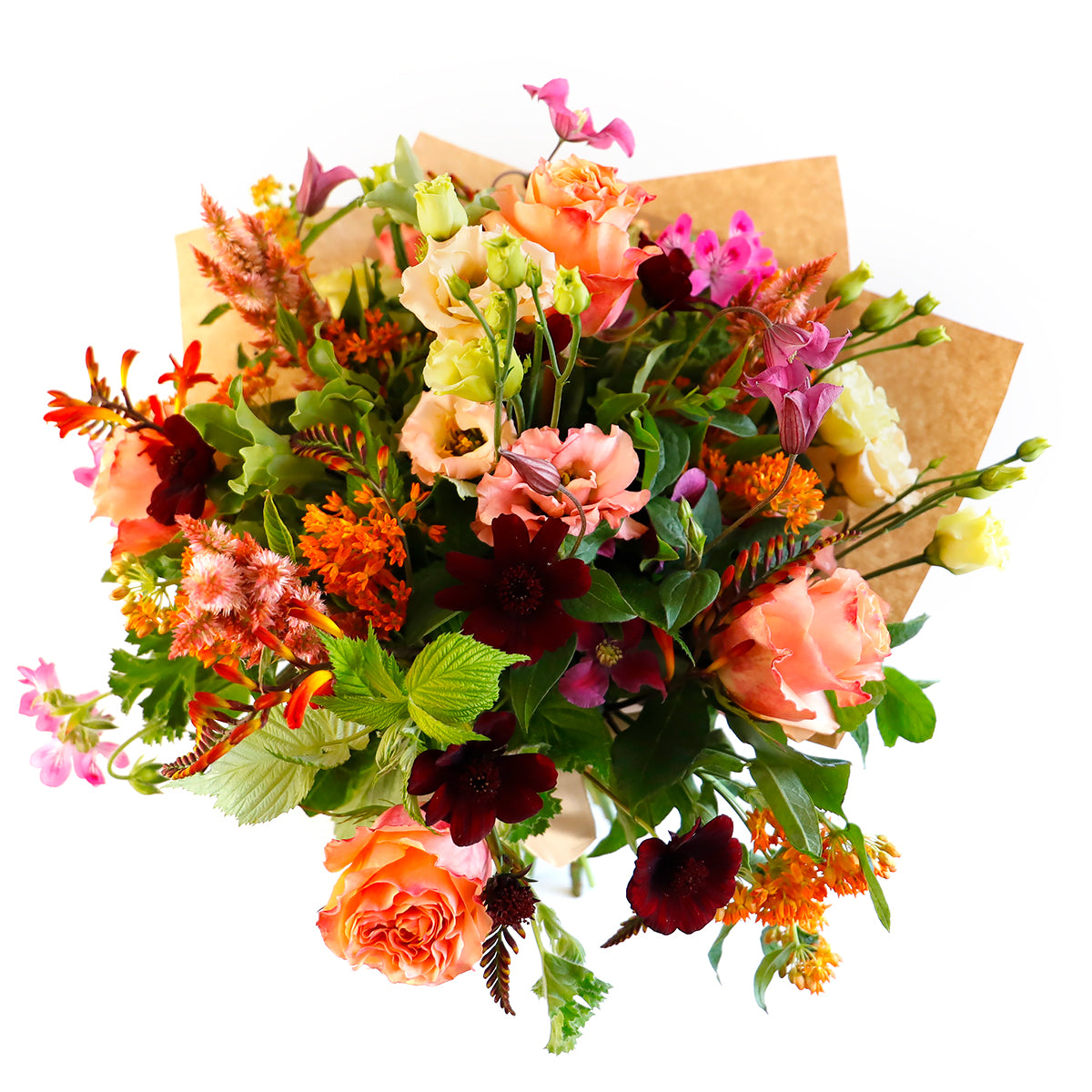 Overhead view of coral roses, cream lisianthus, pink clemetis and other orange flowers wrapped in brown paper