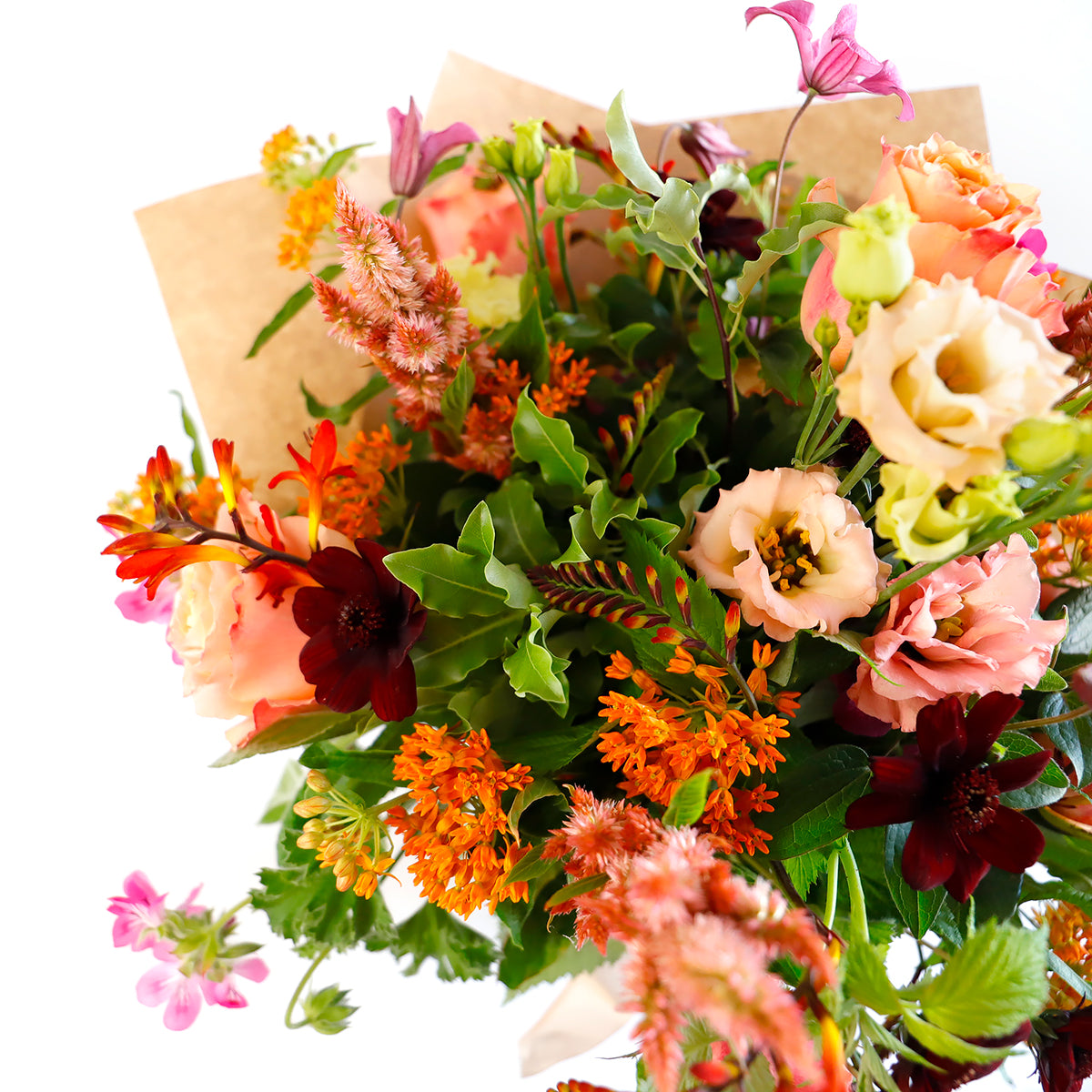 Detail view of coral roses, cream lisianthus, pink clemetis and other orange flowers