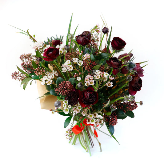 Burgundy ranunculus, wax flower and thistle bouquet