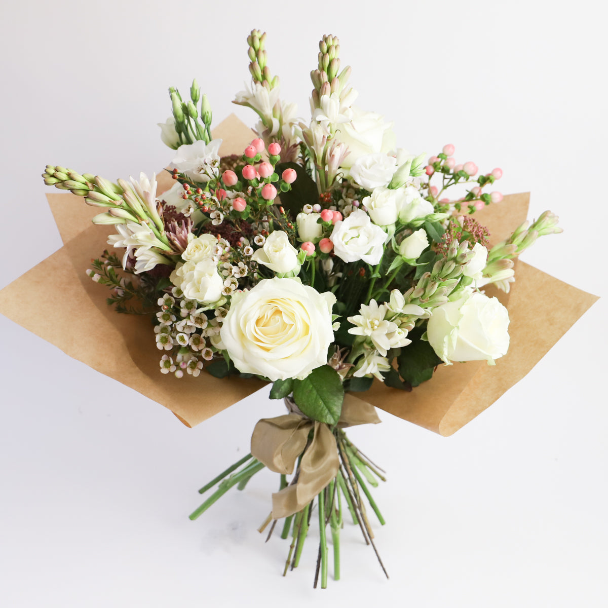 Bouquet of white roses, pink hypericum and tuberose